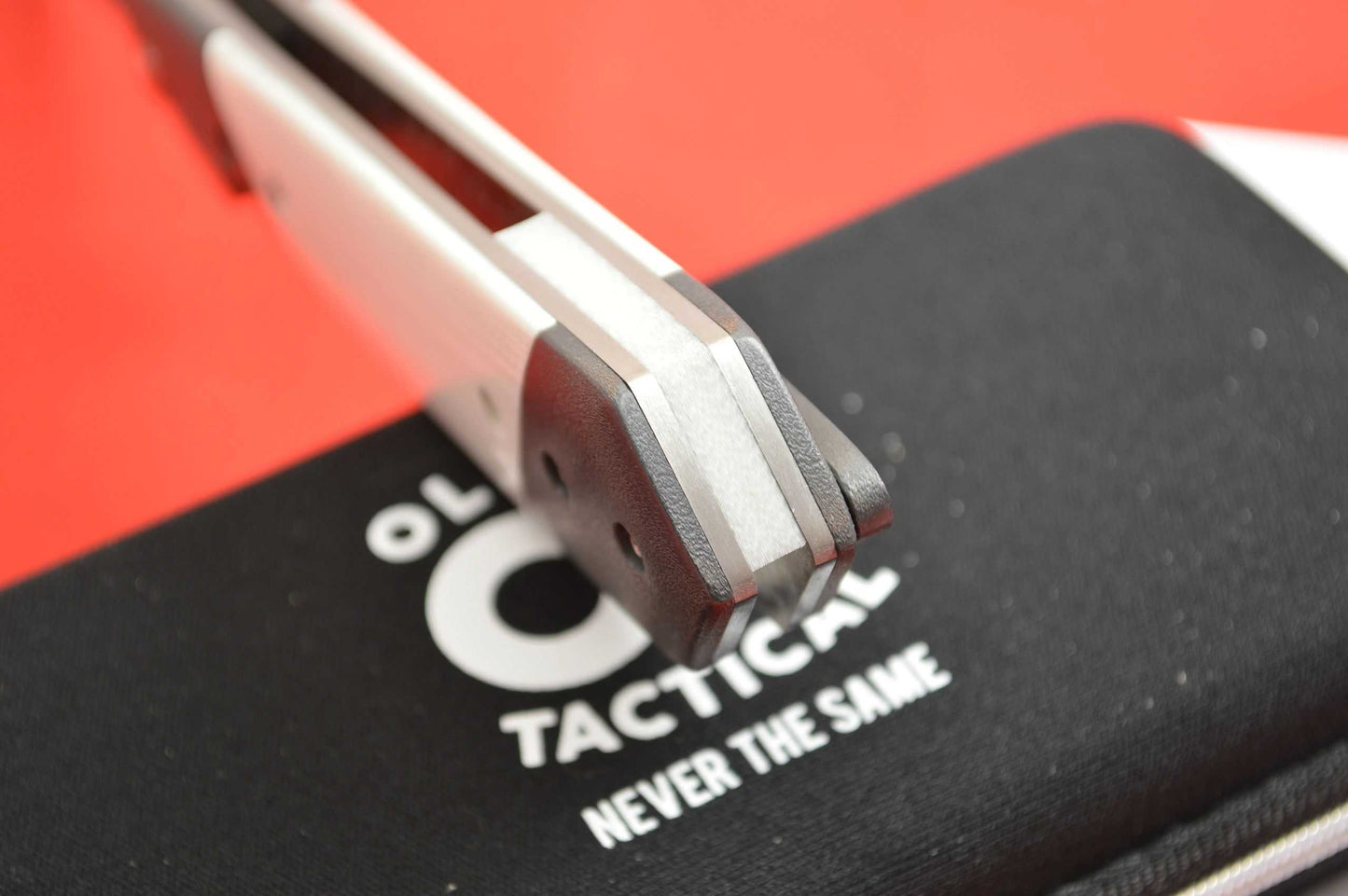 Olamic Cutlery Rainmaker, White G10 Scales, Orange Peel Zirconium Bolsters (SOLD)