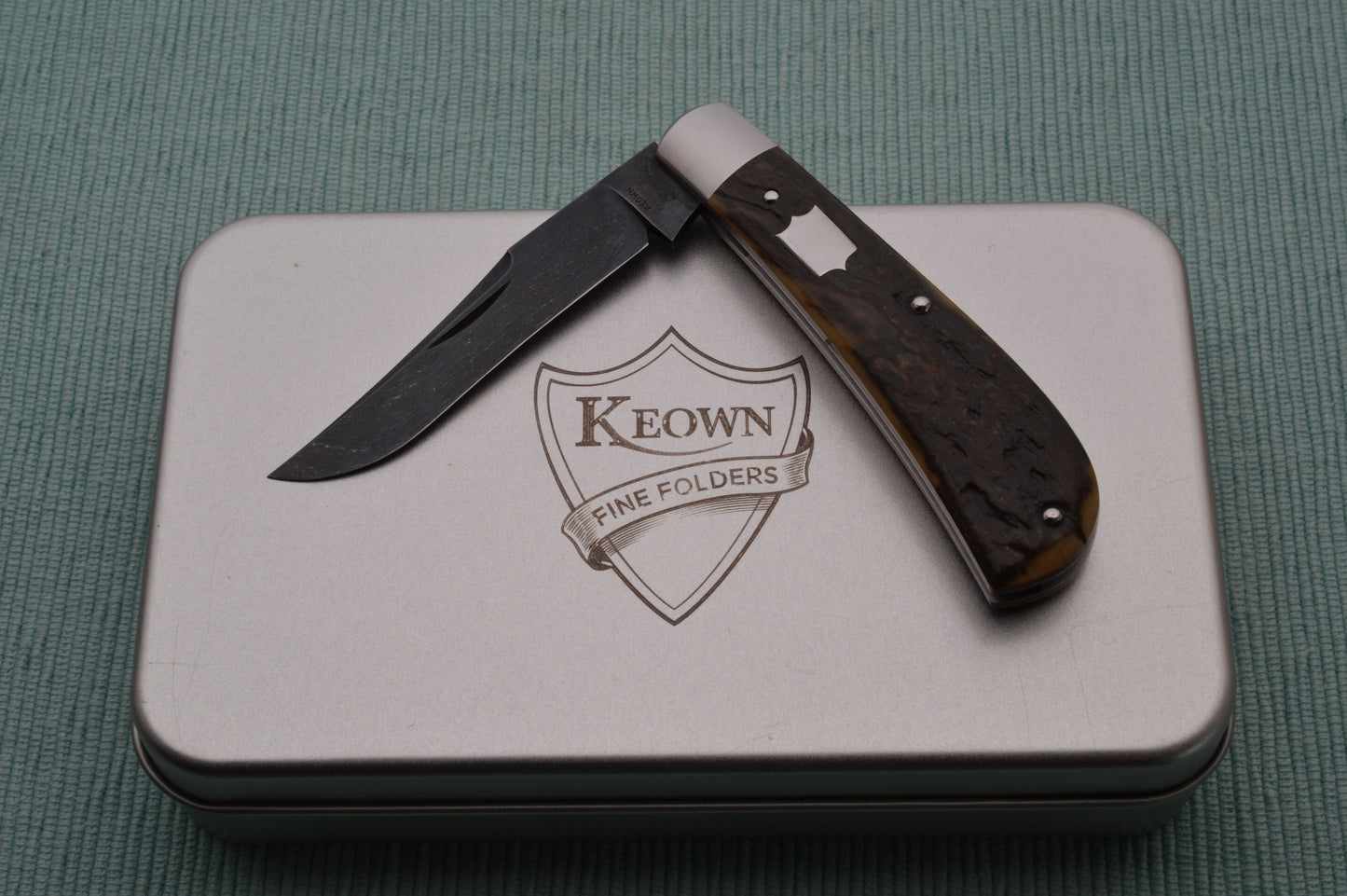 Daniel Keown Blued A2 Trapper, Ancient Fossil Material Slip-Joint Folding Knife (SOLD)