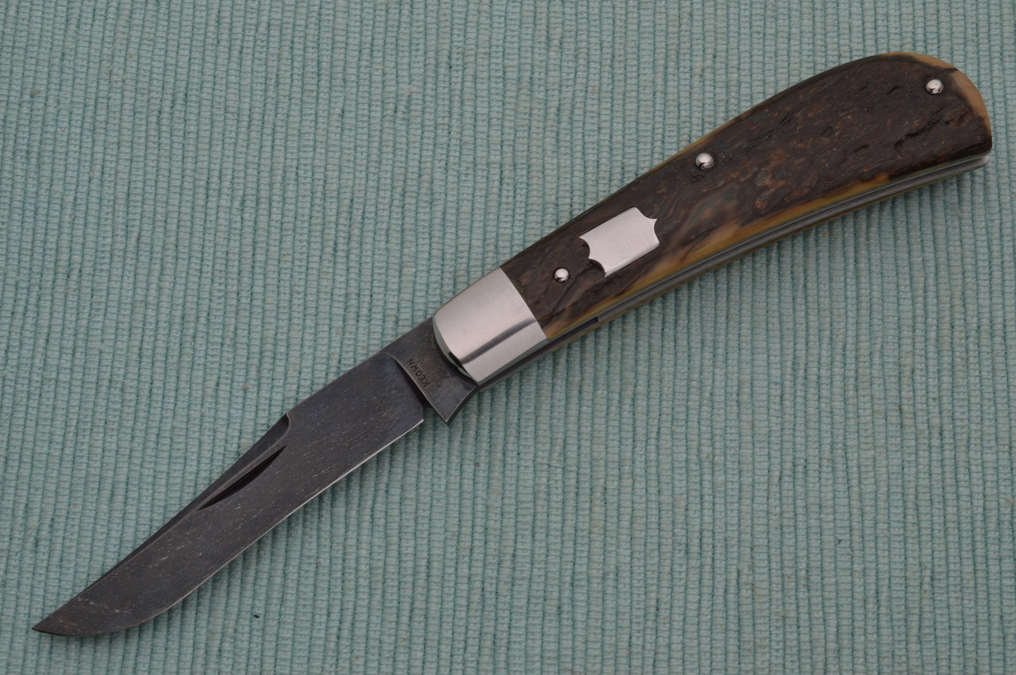 Daniel Keown Blued A2 Trapper, Ancient Fossil Material Slip-Joint Folding Knife (SOLD)