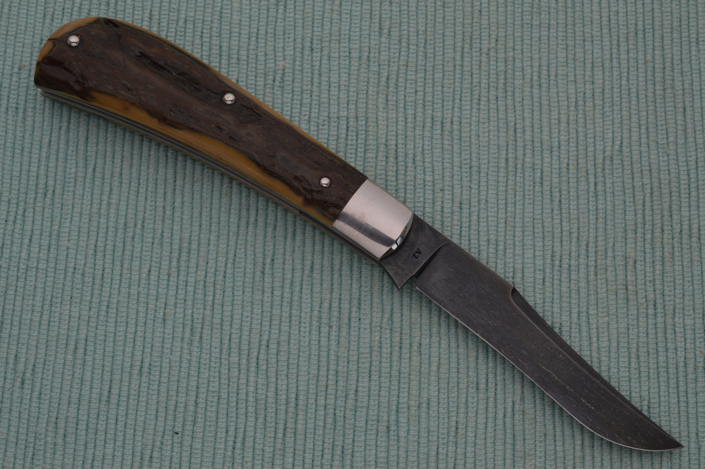 Daniel Keown Blued A2 Trapper, Ancient Fossil Material Slip-Joint Folding Knife (SOLD)