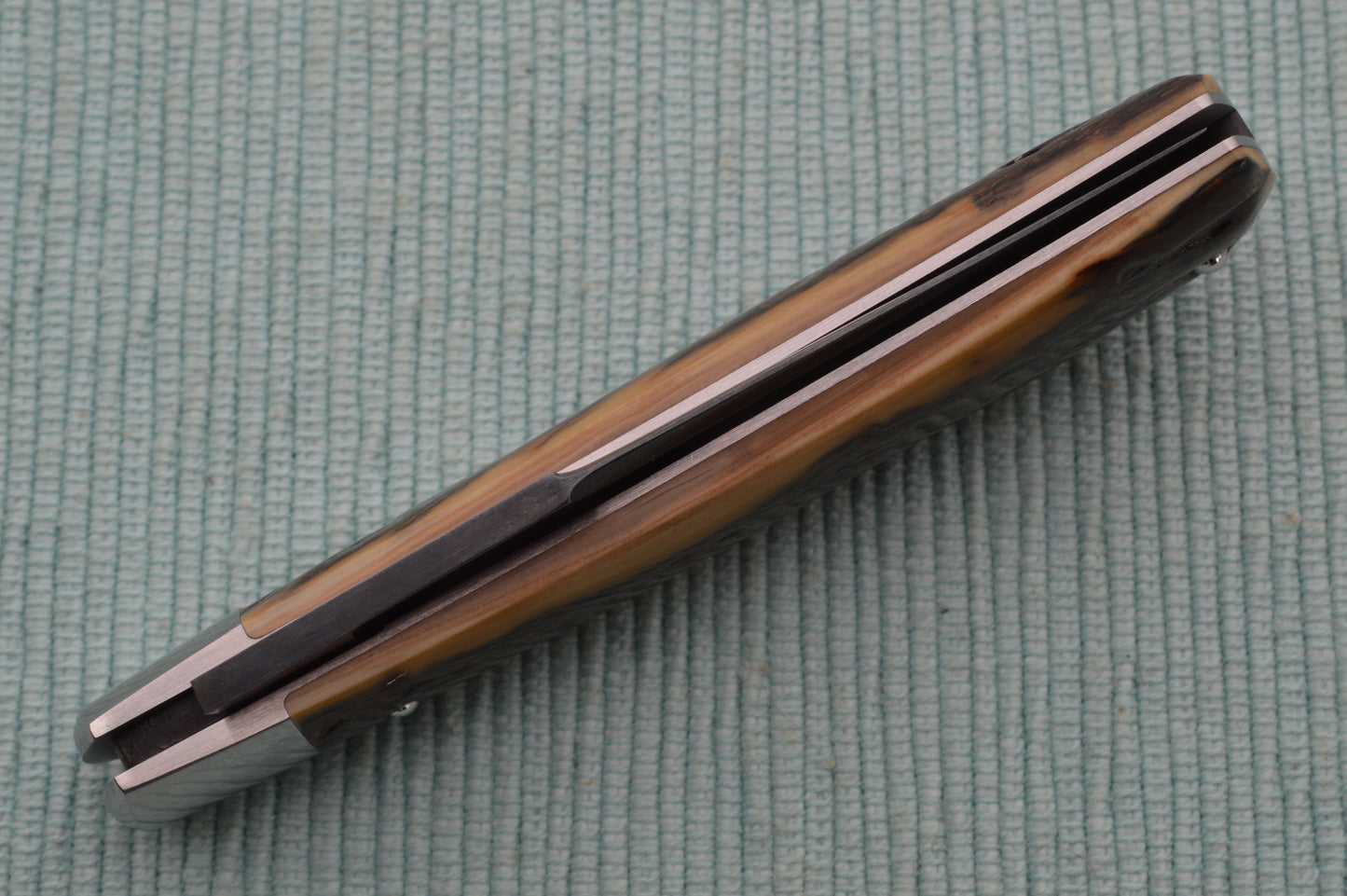 Daniel Keown Blued A2 Trapper, Ancient Fossil Material Slip-Joint Folding Knife (SOLD)