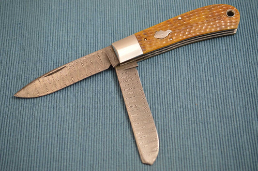 Luke Swenson Damascus 2-Blade Jigged Bone Dog's Head Trapper (SOLD)